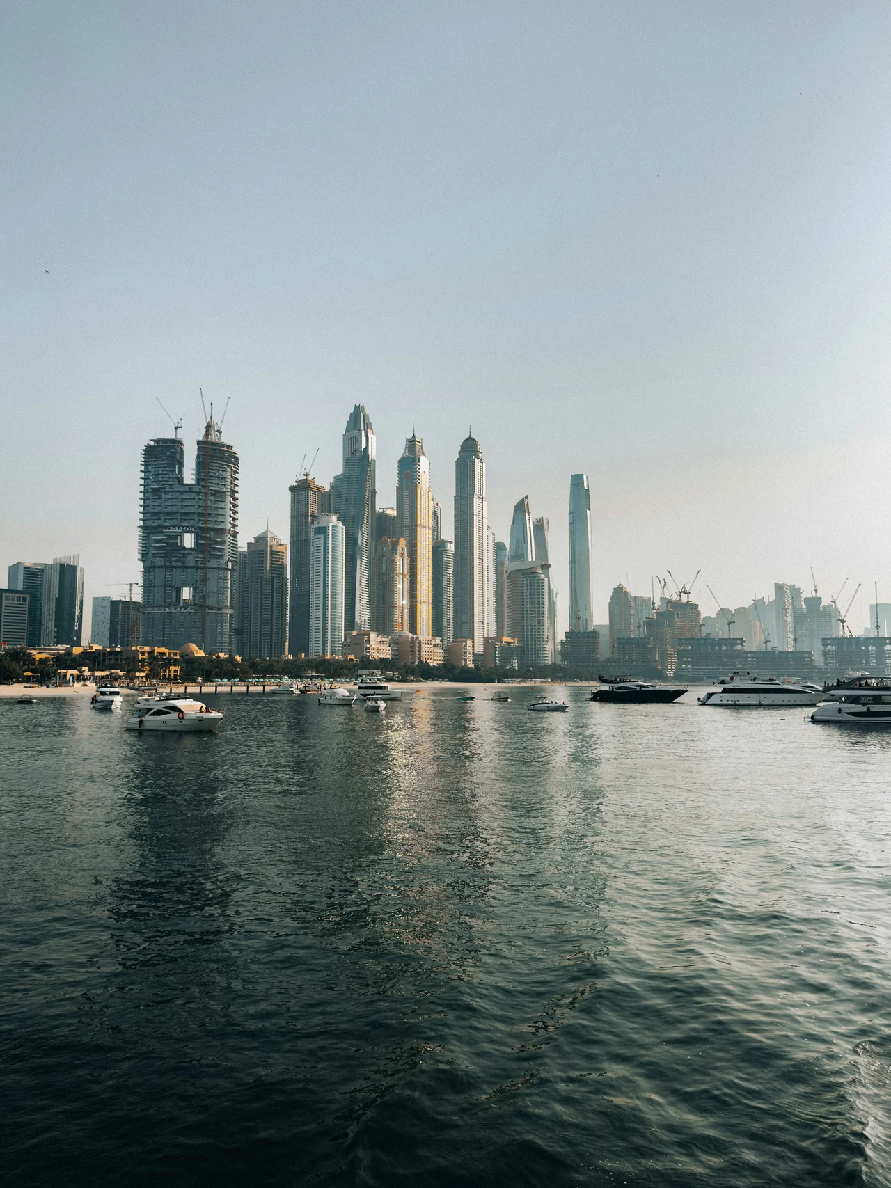 Dubai Marina skyline and yachts on the waterfront.